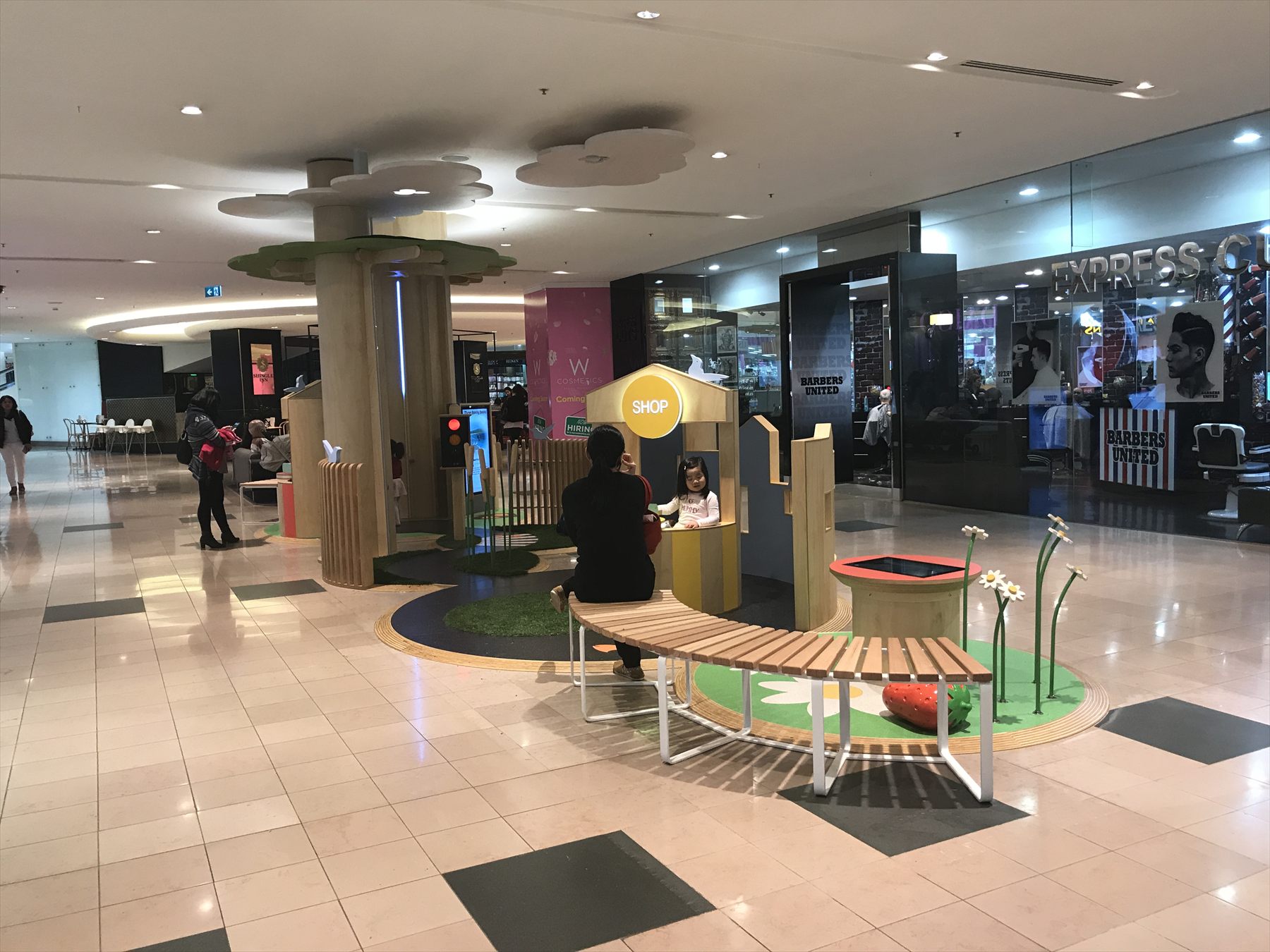 A circular children's play area with a tree structure and interactive floor at Chadstone