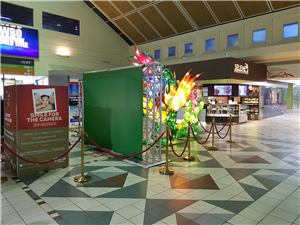 Smile for the camera augmented reality photo booth with a green screen beside lantern displays
