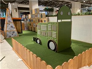 A tractor, windmill and picket fence in a farm-themed kids play area at Grand Central