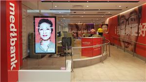A Medibank store front with a portrait screen and a reception counter