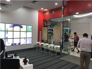 A video wall and seating inside a Medibank store