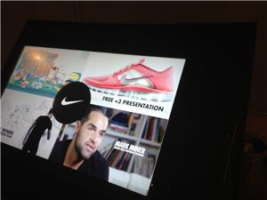 A tablet screen showing a Nike Free presentation on a black stand