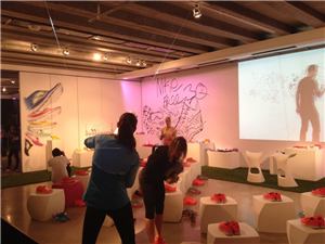 Guests browsing red Nike Free shoes at an interactive projection event