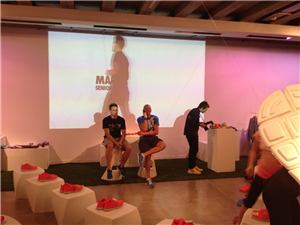 Guests and a Nike representative seated beside a drawing projection