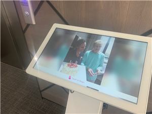 A close view of a Blue Cross touch screen showing residents' photos