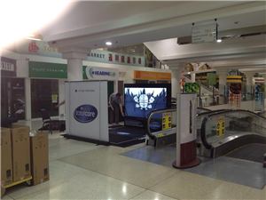 A Purina Total Care interactive screen display in a shopping centre beside an escalator