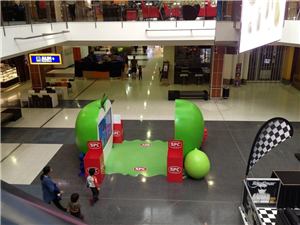 A giant green apple and fruit display with an interactive screen for SPC