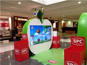 The SPC giant apple interactive video wall with red SPC boxes
