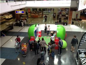 Shoppers around the SPC giant apple interactive display seen from above