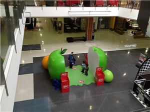 A child and parent playing the SPC giant apple interactive game
