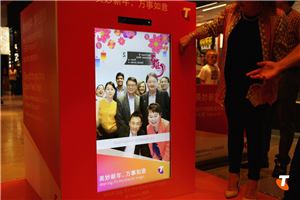 A woman using a Telstra Lunar New Year interactive photo screen