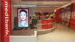 The front of a Medibank store with a portrait digital screen