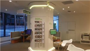 A white pillar with healthy recipe cards and screens in a Medibank Private store