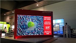 The Amcom video wall showing a traffic scene in a dark exhibition hall