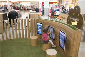 A child using wall-mounted touch screens in the Altona Gate play pod