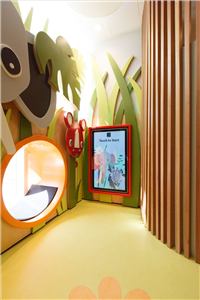 An elephant mural and interactive screen in a jungle-themed kids room