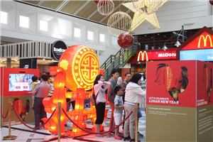 A queue of shoppers at the Lunar New Year lantern with an interactive screen