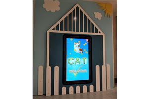 A kids game touch screen in a house-shaped frame with a cat on screen at Brandon Park
