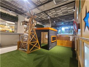 A windmill and black cubby on artificial grass at Grand Central Shopping Centre